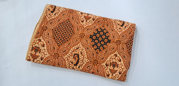 folding jarik or traditional Indonesian batik cloth isolated on white background. Javanese tradisional cloth	
