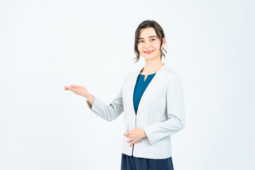 Caucasian female business person guiding in front of a white background