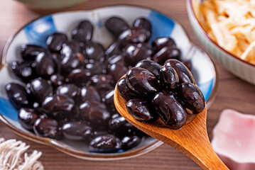 Sweet simmered black beans in a plate   