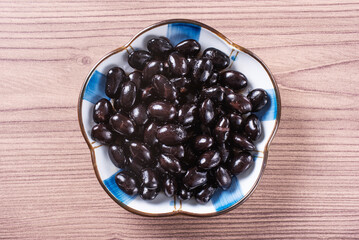 Sweet simmered black beans in a plate   