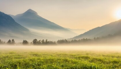 Obraz premium Majestic sunrise over a misty mountain valley