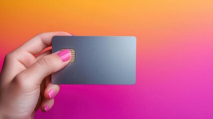 Hand holding a sleek metal credit card against a gradient background, elegant and modern, payment, luxury finance
