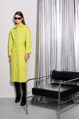 High fashion portrait of young woman in lemon long dress. Sunglasses,