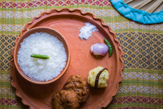 Pakhala or panta bhat is fermented rice popular in indian states of odisha and bengal. The staple summer food is served on traditional clay plate.