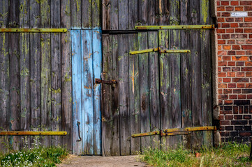 Old and worn wooden door (on an abandoned railway station)