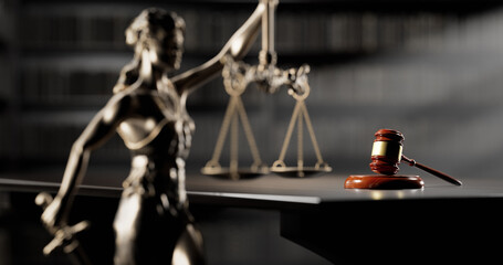 Legal Concept: Themis is the goddess of justice and the judge's gavel hammer as a symbol of law and order on the background of books