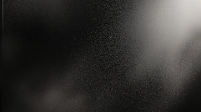 Black matte textured background with floating dust particles illuminated by soft light in the top right corner, creating a deep contrast between black and white. This abstract design emphasizes textur