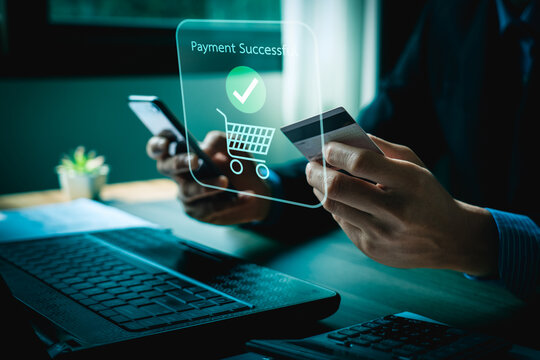 Person Making Online Payment with Credit Card on Laptop, Holographic Interface Showing Payment Successful and Shopping Icons, Representing E-commerce and Digital Transactions