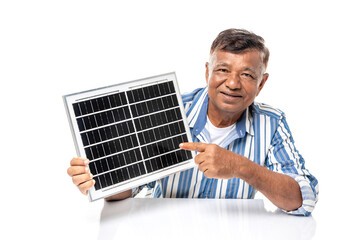 Asian senior man smiling holding solar cell panel isolated on white background, renewable energy,...
