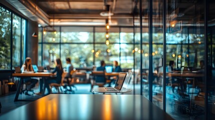 Fototapeta premium A modern workspace featuring a blurred view of professionals engaged in collaborative work, with ample natural light streaming through large windows, creating an inspiring environment for productivity