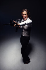 Woman, rifle and professional spy in studio, angry corporate killer and fight on black background. Female person, mafia boss and gun for fancy gangster business, criminal agent and danger to security
