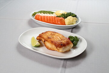 Grilled Cod with vegetables on a plate