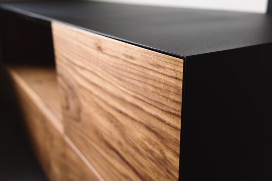 Closeup details of modern tv stand made from walnut and powder coated steed