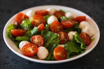 Salad with mozzarella balls tomatoes and mix salad