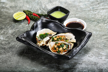 Open half oysters with green onion