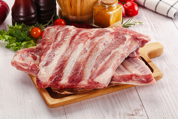 Raw pork ribs over board