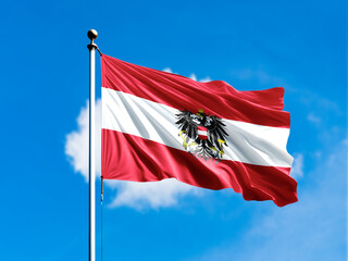 austria flag flying on blur blue clouds background.