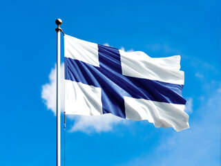 finland flag flying on blur blue clouds background.