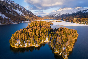 Lake Sils, Switzerland: Dramatic aerial view of the sunset over the Silsersee lake in winter in the Engadine valley in Canton Graubunden in the Swiss alps.
