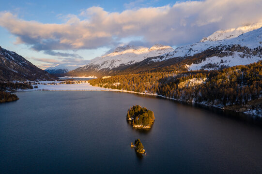 Lake Sils, Switzerland: Dramatic aerial view of the sunset over the Silsersee lake in winter in the Engadine valley in Canton Graubunden in the Swiss alps.
