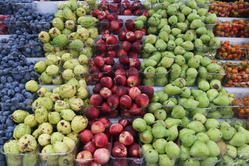 Summer fruits arranged on shelves for sale