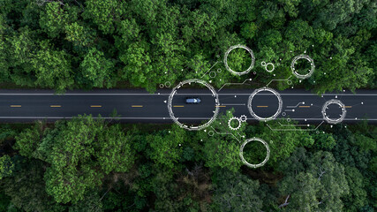 Aerial view car drive in green tree forest road winding road through the forest, Car drive on asphalt road between green tree forest, Electric vehicle EV car drive on asphalt road green tree forest.