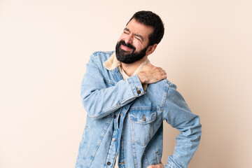 Caucasian man with beard over isolated background suffering from pain in shoulder for having made an effort