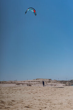 Man kitesurfer on the beach.