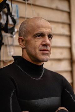 Portrait of confident kite surfer standing at beach.
