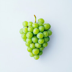 A bunch of green grapes are shown in a close up. The grapes are fresh and shiny, and they are arranged in a way that makes them look like a heart. Concept of freshness and health