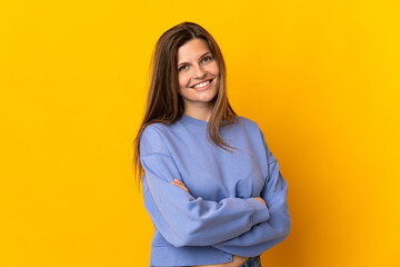 Young Slovak woman isolated on yellow background with arms crossed and looking forward