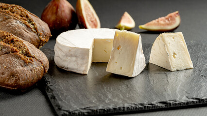 Cheese on a plate with figs and blueberries