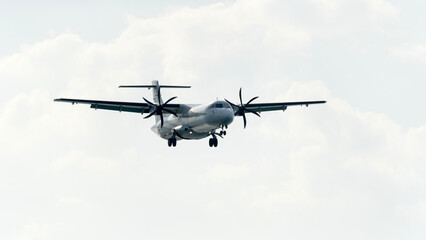 A passenger plane or airliner comes in to land at the airport