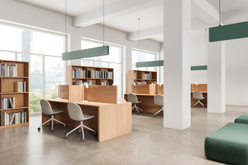 Bright school library interior with workplace and bookshelves, panoramic window