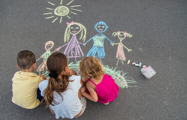 children draw a family with chalk. Selective focus