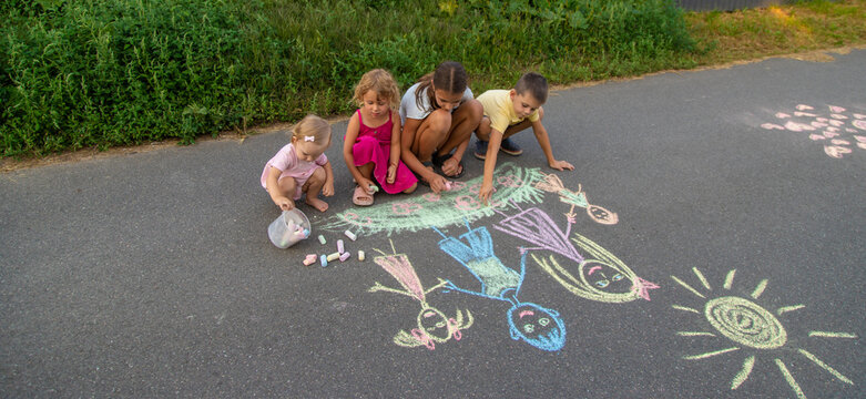 children draw a family with chalk. Selective focus