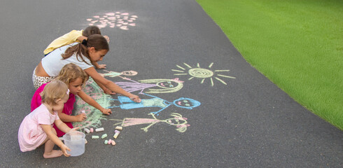 children draw a family with chalk. Selective focus