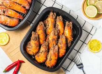 Spicy Pepper Grilled Shrimp with Lemon and fork served in black tray isolated on table top view of taiwan seafood