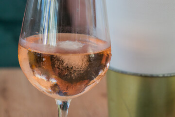 Glass of ice-cold rosé wine, close-up
