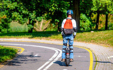 guy on a monowheel ride through the  park
