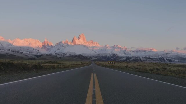 a sunrise zoom in shot of monte fitz roy and the road to el chalten at los glaciares national park in patagonian argentina
