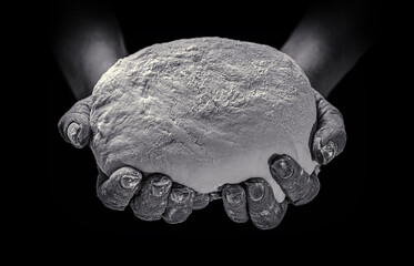 Man giving bread, helping hand concept. Female hands holding raw dough on black background. Hands holding a finished clean dough. Helping the homeless
