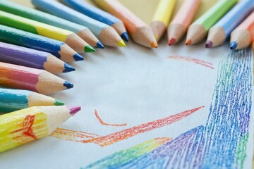 Group colored pencils arranged circle around piece paper Back to