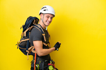 Young rock climber Brazilian man pointing back