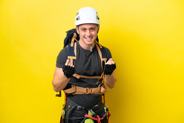 Young rock climber Brazilian man making money gesture