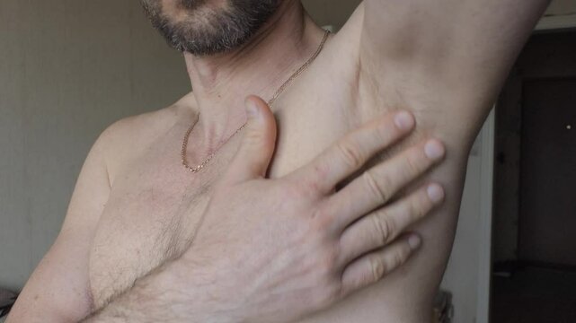 A man shows off his armpit hair
