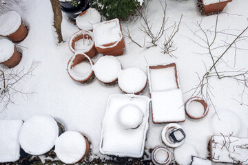 Winter garden with flower pots covered with snow
