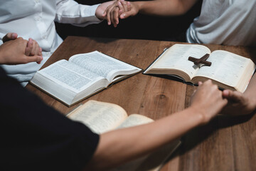 Obraz premium Asian men and women hands praying to god with the bible. Pray for god blessing. Religious beliefs Christian life crisis prayer to god.