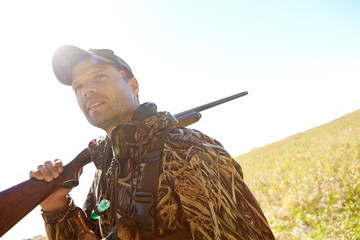 Man, hunter and rifle in outdoor for sport, activity and trophy as wildlife enthusiast. Male...