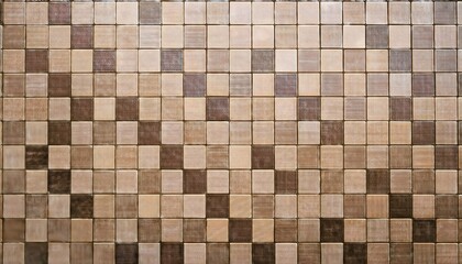 A patterned wall of square tiles in various shades of brown.